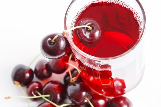 Red drink and ripe cherry berries