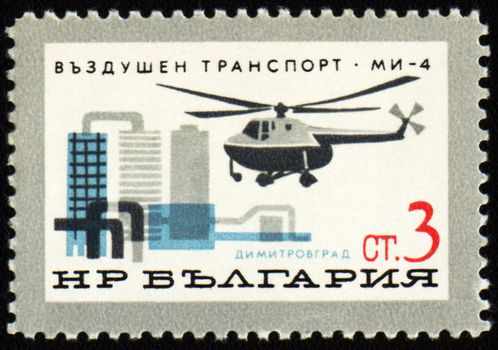 BULGARIA - CIRCA 1965: A stamp printed in Bulgaria shows flying helicopter over the Dimitrovgrad town, series, circa 1965