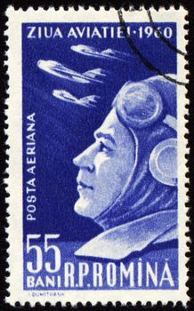 ROMANIA - CIRCA 1960: A stamp printed in Romania shows military flyer and flying planes on Aviation Day, circa 1960