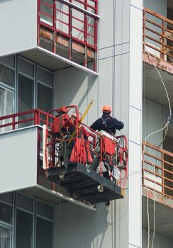 A construction worker on a high wall 