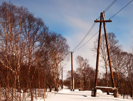 Electric column with wires against the dark blue sky