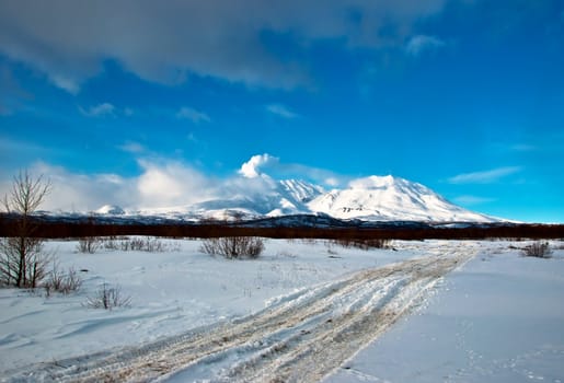 Road to snow to a beautiful volcano in Russia