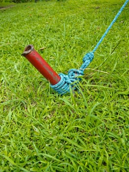 Red iron post and blue knot.