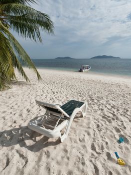 Paradise beach in Rawa island in Malaysia with relax chairs and beach toys