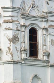 Arc shaped window on old white wall