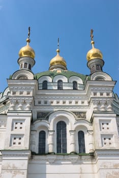 Domes of orthodox church on a blue sky background.