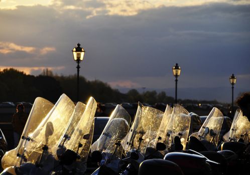 Parked scooters at sunset, Italy