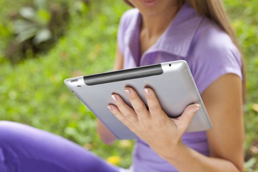 Beautiful Young Woman With Tablet Computer In Park