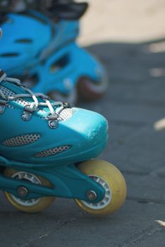 Close-up of used blue inline speedskate sideface.