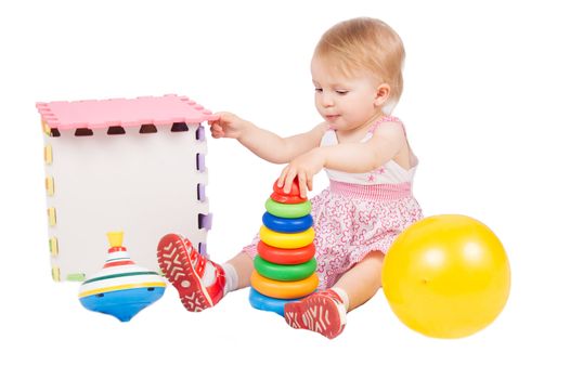 Baby girl playing toys over white