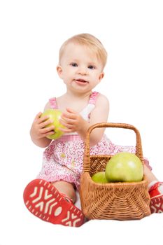 Baby girl with basket and apples over white