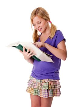 Beautiful happy teenager school girl pointing in books to read and learn, standing and smiling, isolated.