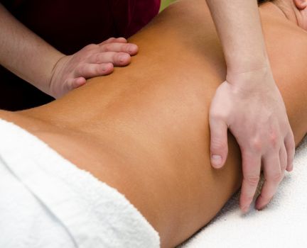 closeup of young woman getting a back massage