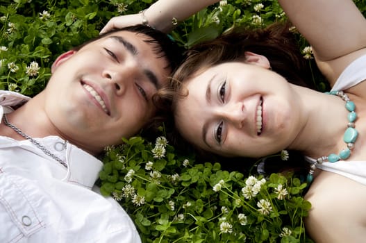 man and the woman lay together on a grass