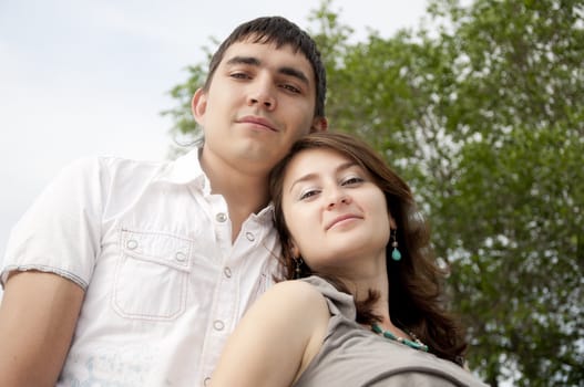 man and the woman stay together on a grass