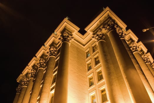 Columns of a building. A night photo, light from street lanterns