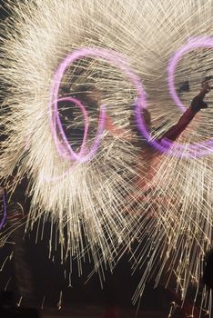 Many golden fireworks bursts at fireworks festival.