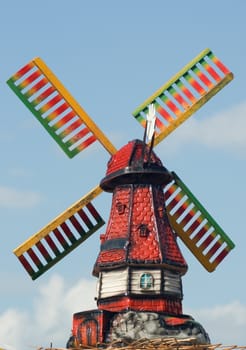 Ceramic toy wind mill with colored blades