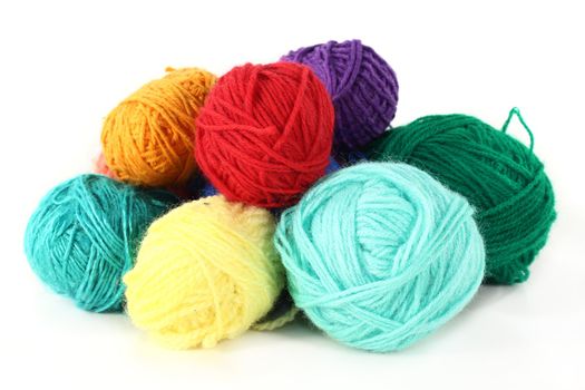 colorful balls of wool on a white background