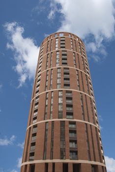 A Red Cylindrical Apartment Block under a blue sky