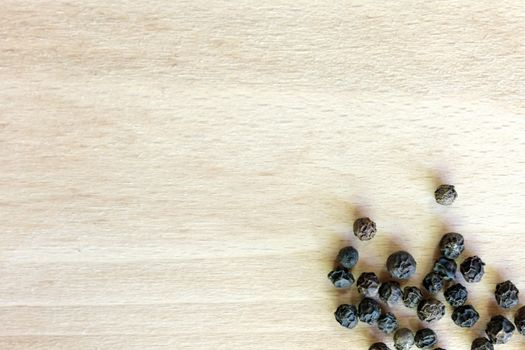 Black Pepper grains in the bottom right corner of the chopping board