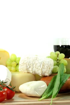 Cheese with fresh grapes, tomatoes and red wine