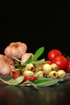 olives with olive branch, and fresh tomatoes and garlic