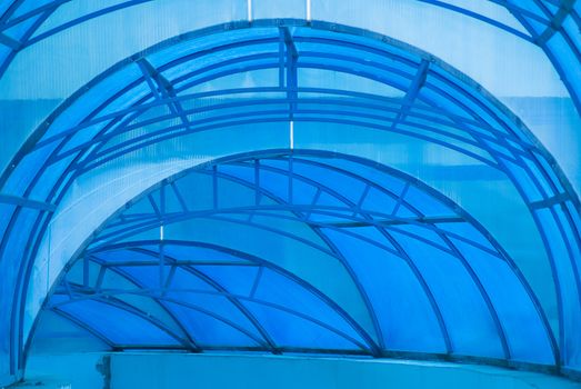 blue transparent arched canopy over the entrance