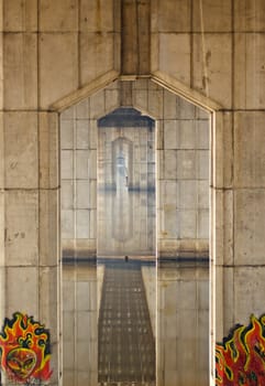 long tonel under the bridge reflected in water