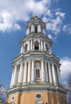 The tall belfry of Kiev pechersk Lavra, Ukraine with gold dome and cross