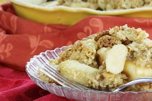 Freshly baked apple crisp. Shallow depth of field with selective focus on the foreground.