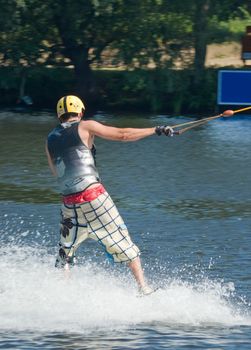 Young man wakeboarding on the lake 