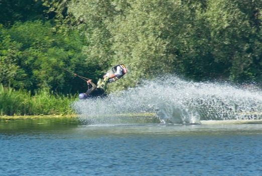 Young man wakeboarding on the lake