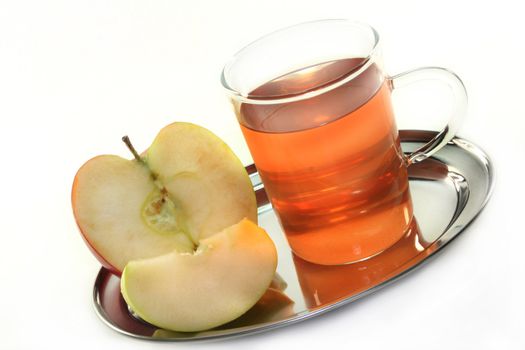 a cup of apple tea with fresh apples