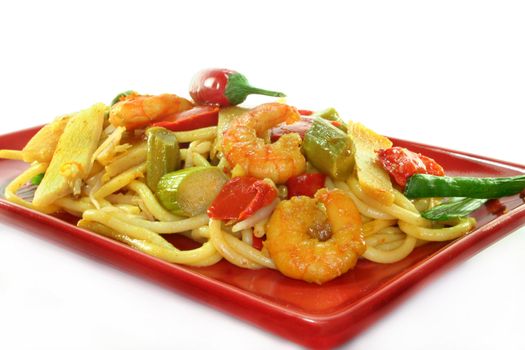 Asian noodles with shrimp and vegetable stir-fry on Asian dishes