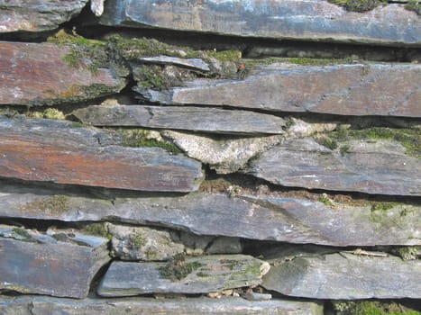 The close-up of an old stone wall for texture or background