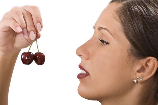 Close-up image of a woman with cherries in her hand.