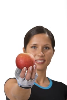 Young sportsgirl offering a red apple-a suggestion for healthy eating.