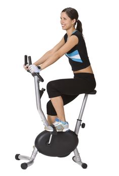 Girl riding a fitness bicycle against a white background.