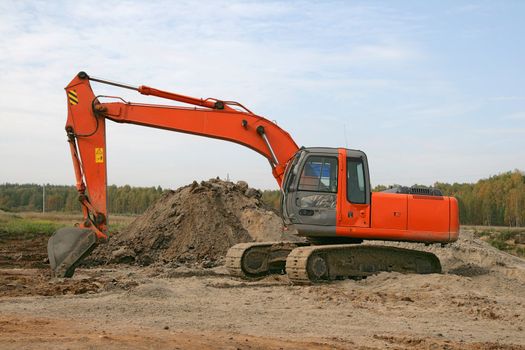 Photo of a working excavator in the countryside