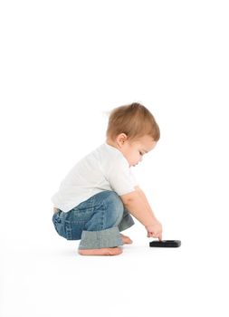 A little boy experimenting with a cellphone
