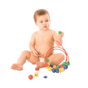 A toddler playing with a multicolored toy