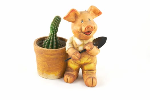 A flowerpot - a pig with a shovel on a white background