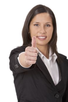 Businesswoman making a characteristic thumb-up gesture - selective focus on the hand.