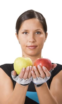 Young sportsgirl offering a red and a green apple and inviting people to a healthy diet.Selective focus on the apples.