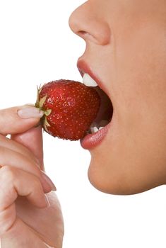 Close-up of a woman mouth bitting into a strawberry.