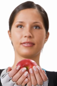 Girl offering a red apple.Selective focus on the apple.