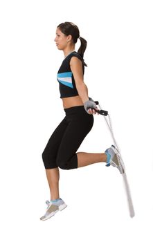 Young woman doing exercises with a jumping rope.