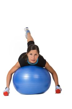Young woman doing an exercise with barbells and a fitness ball 