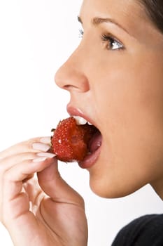 Close-up of a woman mouth bitting into a bitten strawberry.